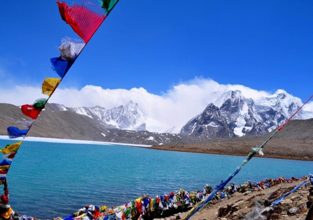 Colorful Buddhist prayer flags fluttering by Gurudongmar Lake