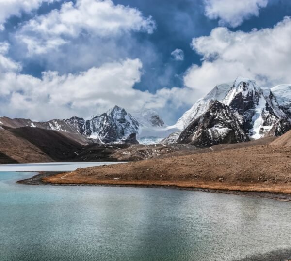 Glacial Tsomgo Lake surrounded by mountains early morning