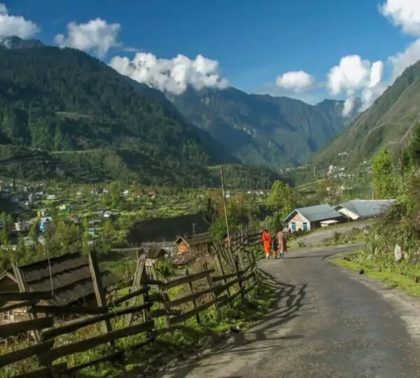 Traditional wooden homes in Lachung with mountain backdrop